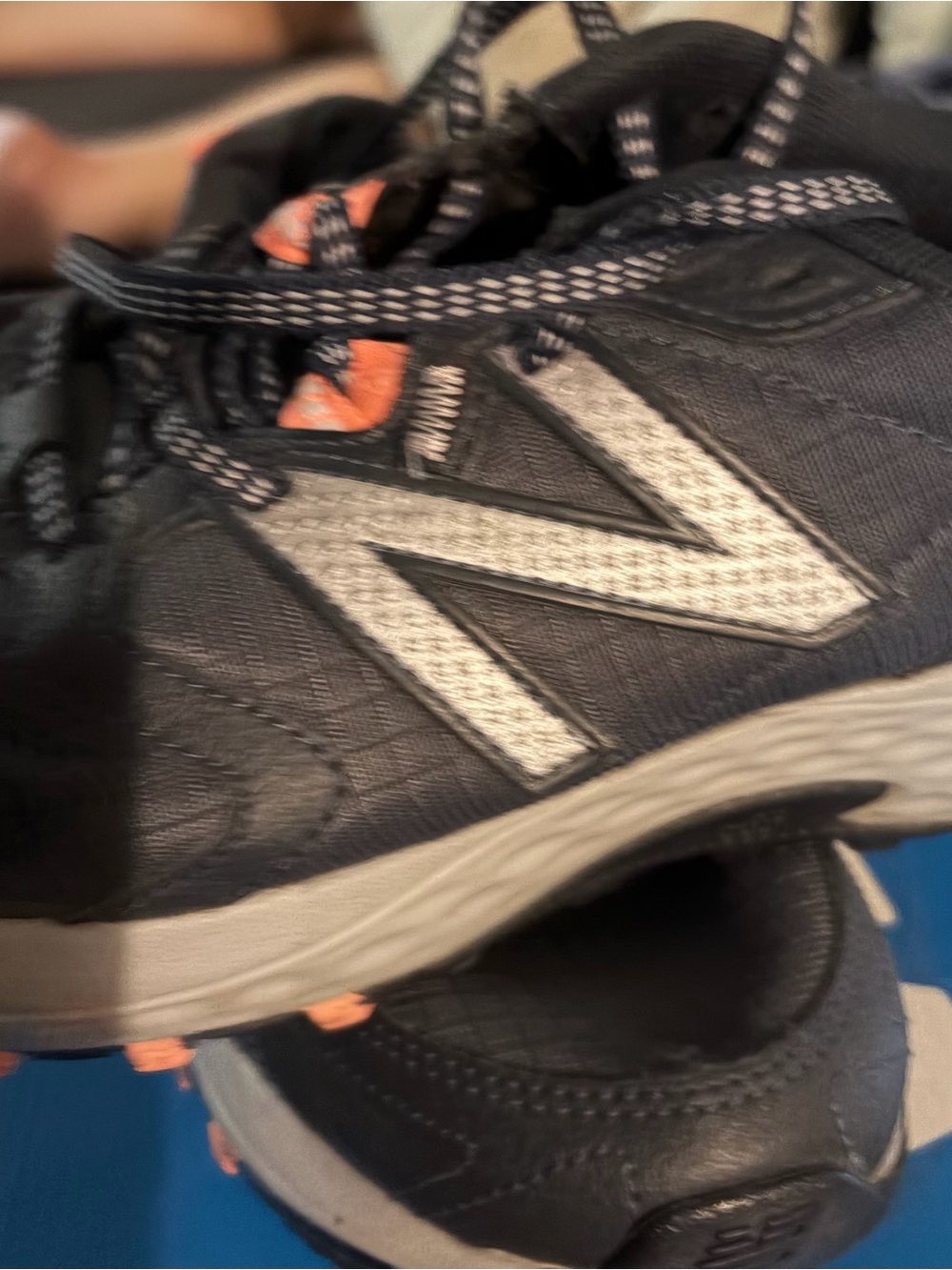 New Balance Black Athletic Sneakers with Gray Logo and Orange Accents